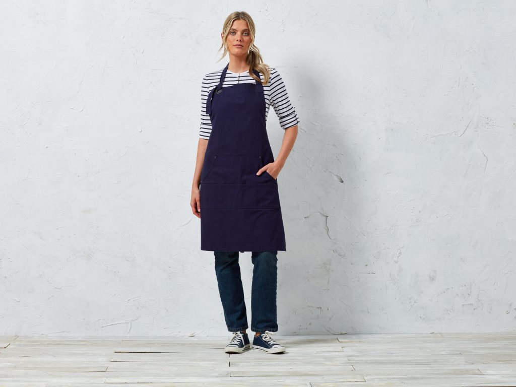 Lady wearing jeans, striped top and full length apron